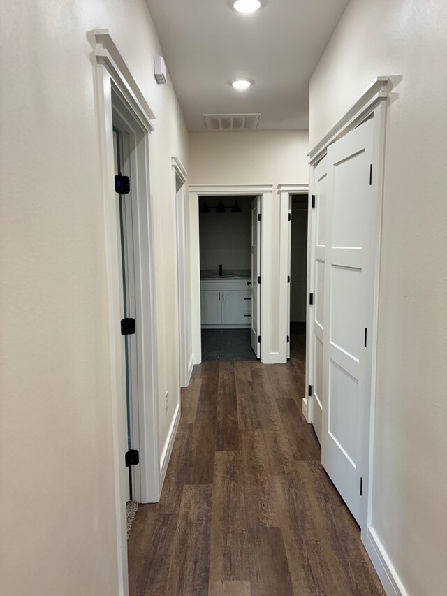 hallway with dark wood-type flooring