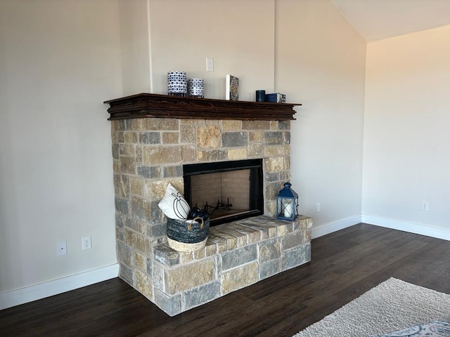 room details with a fireplace, baseboards, and wood finished floors