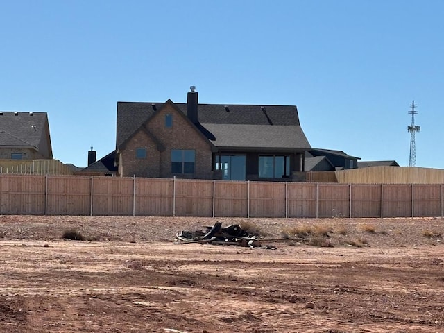 back of property featuring fence