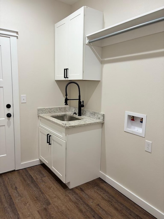 laundry room with washer hookup, dark hardwood / wood-style floors, and sink