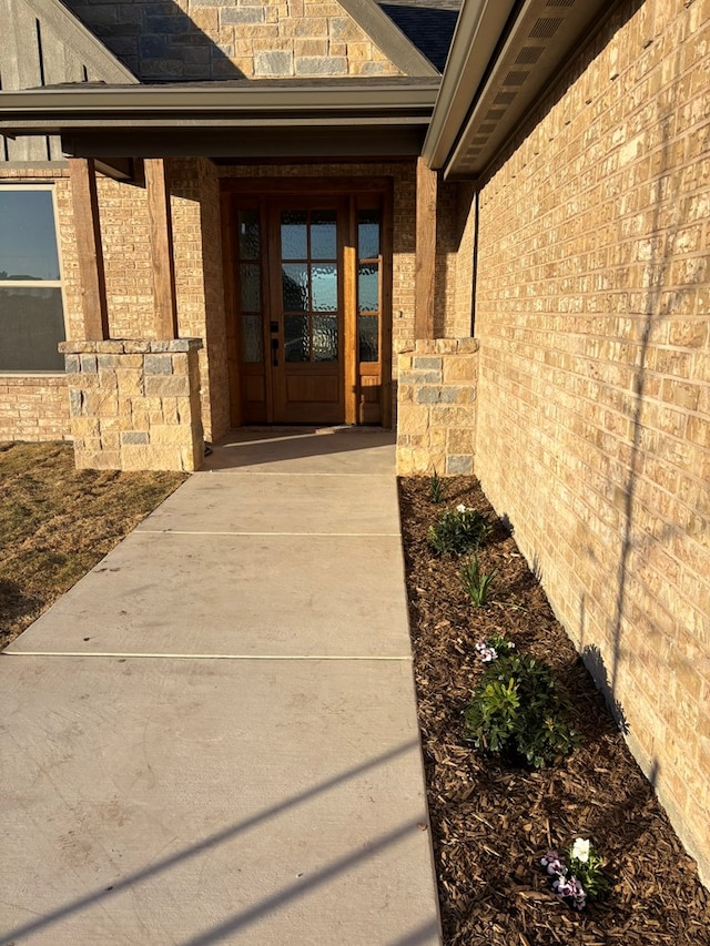 doorway to property with brick siding