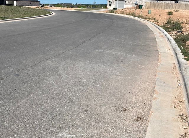 view of street featuring curbs