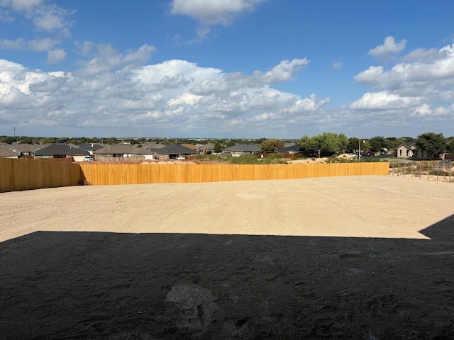 view of yard with fence and a residential view