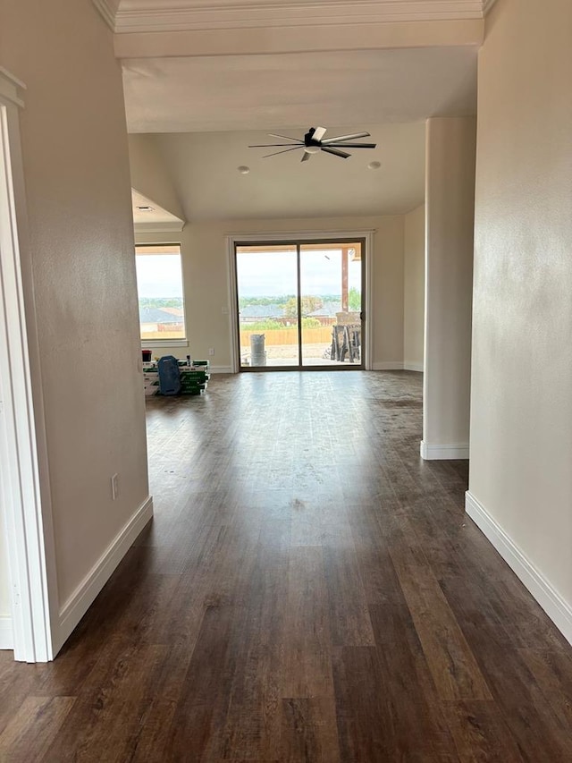 empty room featuring baseboards, dark wood-type flooring, and ceiling fan