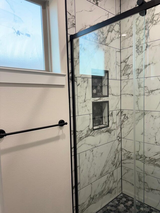 bathroom with a shower with shower door