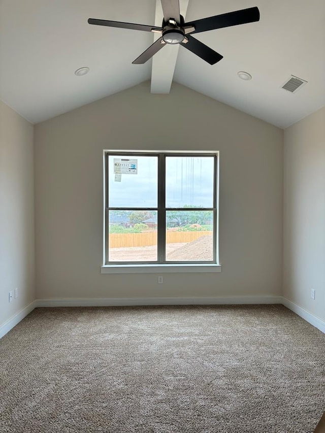 carpeted empty room featuring lofted ceiling with beams and ceiling fan