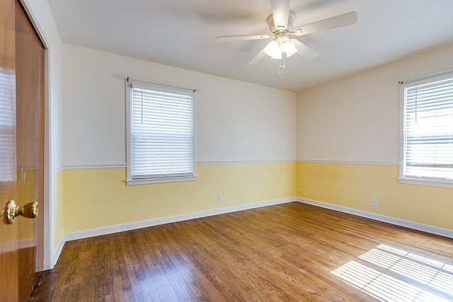 unfurnished room featuring wood-type flooring, a healthy amount of sunlight, and ceiling fan