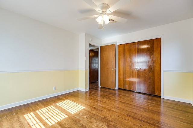 unfurnished bedroom featuring hardwood / wood-style flooring and ceiling fan