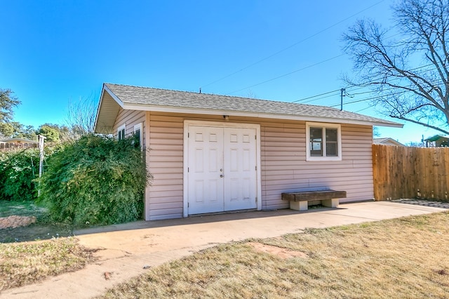 view of outbuilding featuring a lawn