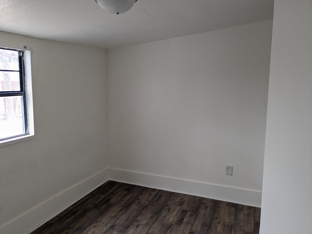 spare room with dark hardwood / wood-style floors