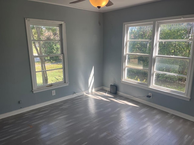 unfurnished room with plenty of natural light, dark hardwood / wood-style floors, and ceiling fan