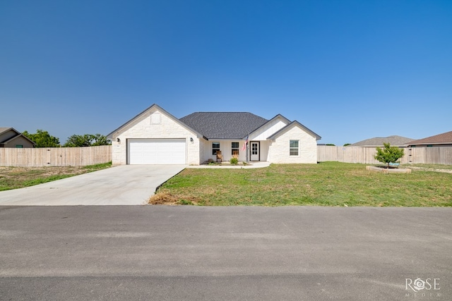 2846 Ricks Dr, San Angelo, TX 76905 - view of front facade with driveway, a garage, and stone siding