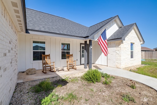 2846 Ricks Dr, San Angelo, TX 76905 - back of property featuring a shingled roof, board and batten siding, and entry steps