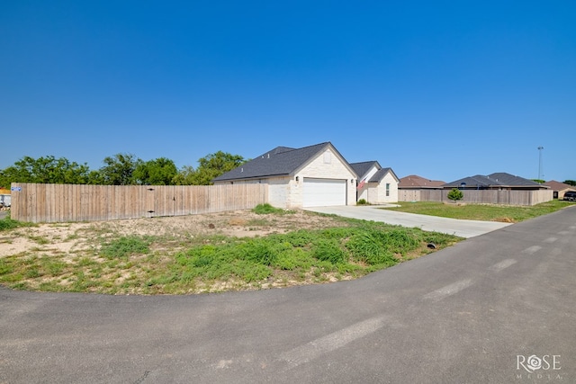 2846 Ricks Dr, San Angelo, TX 76905 - view of property exterior featuring concrete driveway, an attached garage, and a residential view