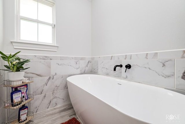 2846 Ricks Dr, San Angelo, TX 76905 - full bathroom with a freestanding tub and wood finished floors