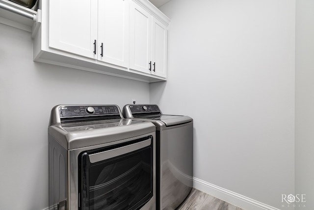 2846 Ricks Dr, San Angelo, TX 76905 - laundry area featuring cabinet space, washer and dryer, and wood finished floors