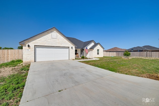 2846 Ricks Dr, San Angelo, TX 76905 - view of front of house with concrete driveway, stone siding, and a garage