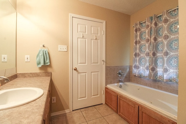 5905 Stratford Ave, San Angelo, TX 76901 - full bathroom with vanity, tile patterned flooring, a textured ceiling, and a bath
