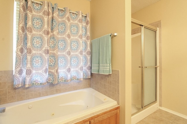 5905 Stratford Ave, San Angelo, TX 76901 - bathroom with tile patterned floors, a shower stall, and a bath