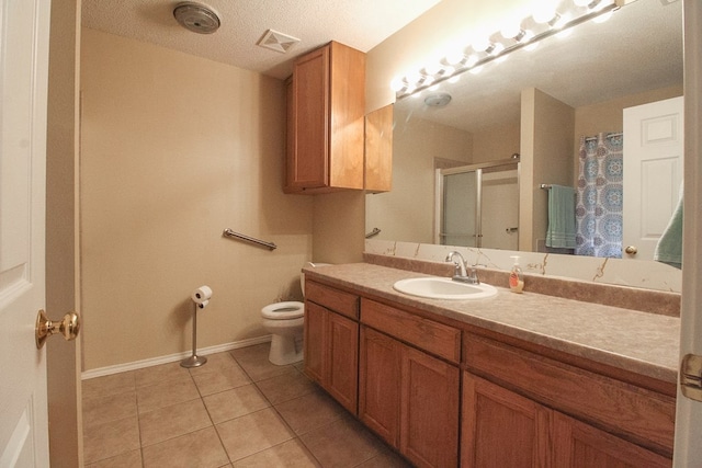 5905 Stratford Ave, San Angelo, TX 76901 - bathroom featuring visible vents, a shower stall, vanity, tile patterned floors, and baseboards