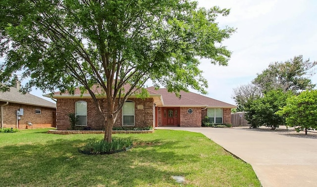 5905 Stratford Ave, San Angelo, TX 76901 - ranch-style house with fence, concrete driveway, brick siding, and a front yard