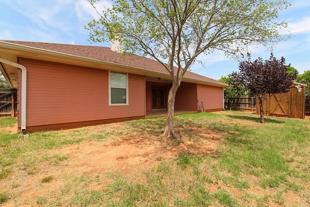 5905 Stratford Ave, San Angelo, TX 76901 - rear view of house with a lawn, fence, and a chimney