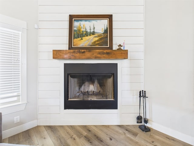 8353 Chad Rd, San Angelo, TX 76957 - detailed view of baseboards, wood finished floors, and a fireplace