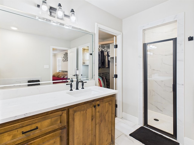 8353 Chad Rd, San Angelo, TX 76957 - full bath with a marble finish shower, a walk in closet, ensuite bathroom, vanity, and marble finish floors