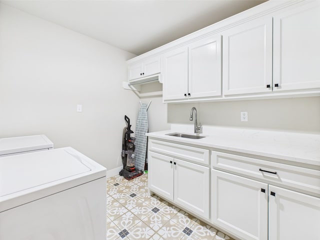 8353 Chad Rd, San Angelo, TX 76957 - laundry area featuring cabinet space, washer and dryer, baseboards, and light tile patterned floors