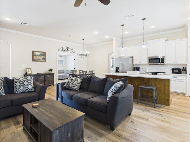 8353 Chad Rd, San Angelo, TX 76957 - living room featuring a ceiling fan, light wood-style floors, a chandelier, crown molding, and recessed lighting