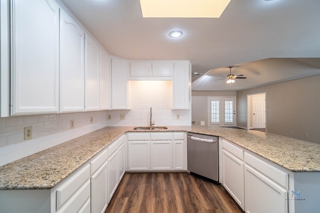 kitchen with sink, white cabinetry, dark hardwood / wood-style floors, dishwasher, and kitchen peninsula