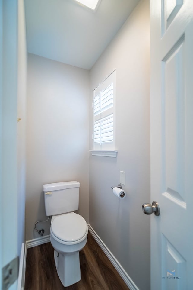 bathroom with hardwood / wood-style floors and toilet