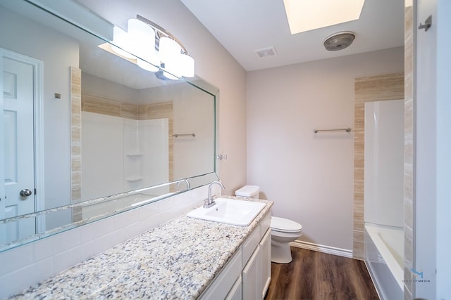 full bathroom featuring vanity, wood-type flooring, toilet, and shower / bath combination