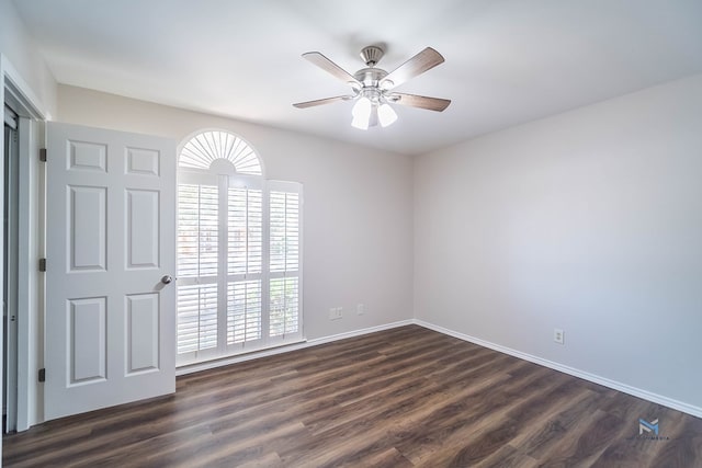 empty room featuring dark wood-type flooring, ceiling fan, and a healthy amount of sunlight