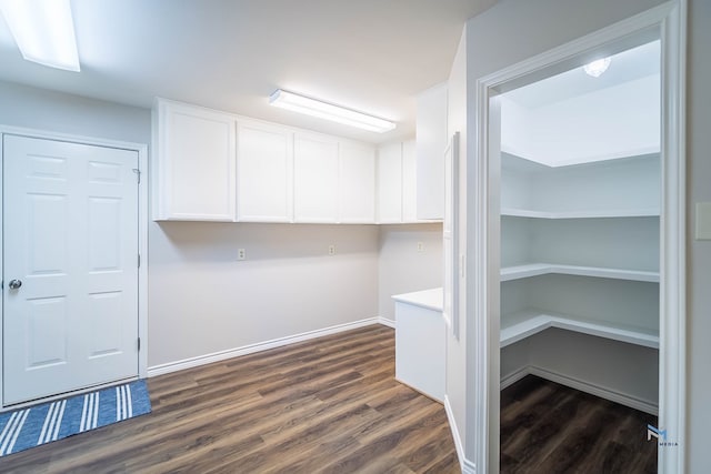 laundry area with dark hardwood / wood-style floors