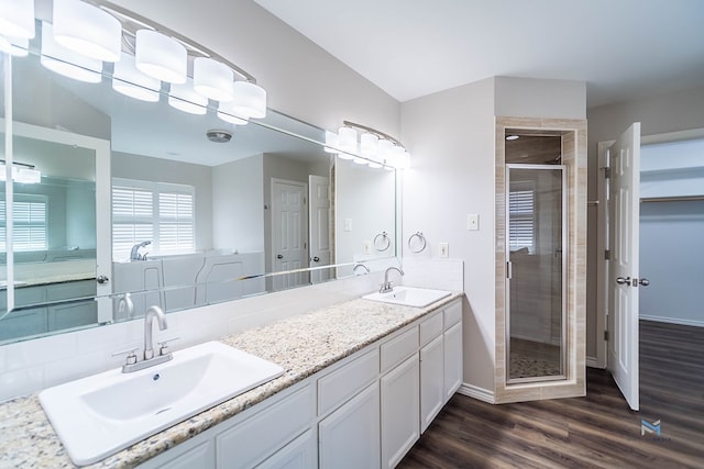 bathroom with vanity, wood-type flooring, and walk in shower