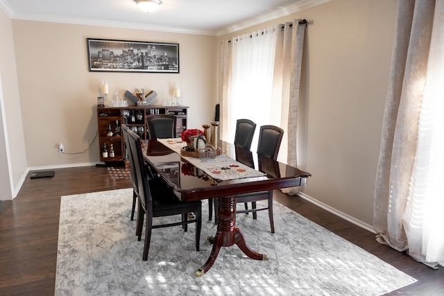 dining room with dark hardwood / wood-style flooring and ornamental molding