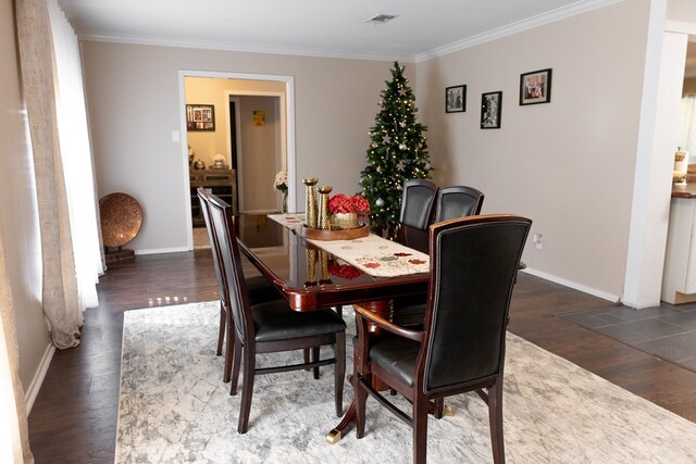 dining area with crown molding and dark hardwood / wood-style floors