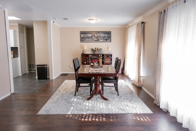 dining room with crown molding and dark hardwood / wood-style floors