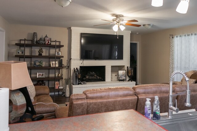 living room featuring a fireplace and ceiling fan