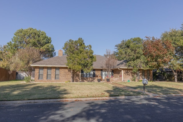 ranch-style home with a front lawn