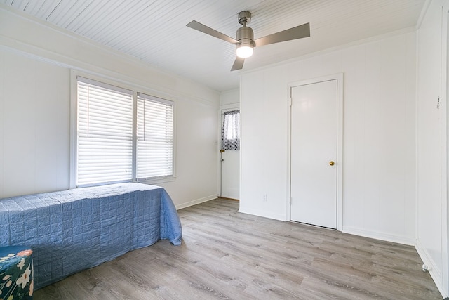 bedroom with ornamental molding, ceiling fan, and wood finished floors