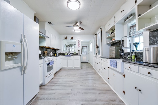 kitchen featuring open shelves, a sink, light wood-style floors, ceiling fan, and white appliances