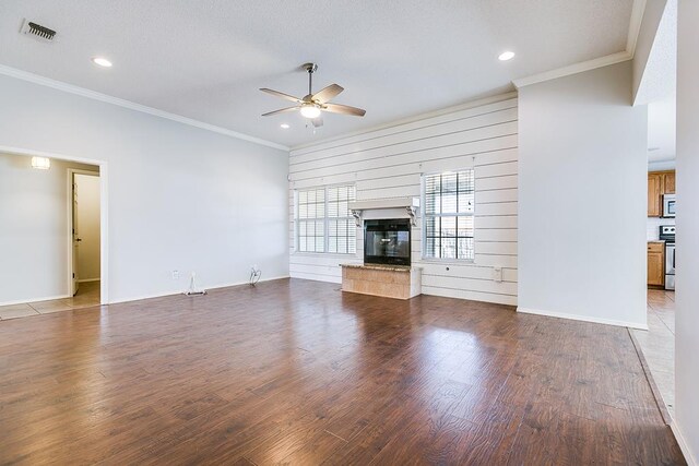 unfurnished living room featuring ornamental molding, hardwood / wood-style floors, and ceiling fan