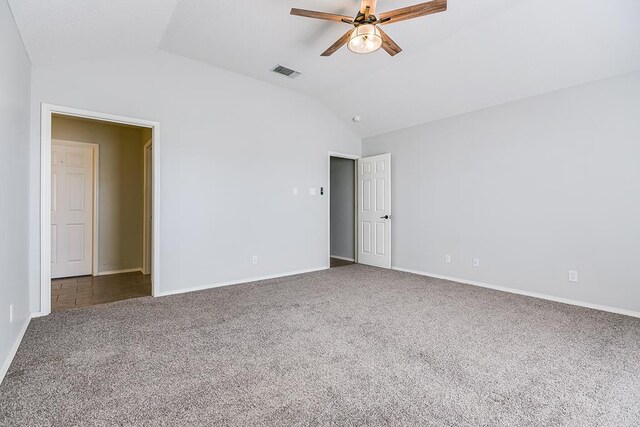 carpeted empty room with lofted ceiling and ceiling fan