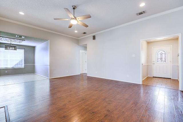 spare room featuring crown molding, hardwood / wood-style floors, a textured ceiling, and ceiling fan