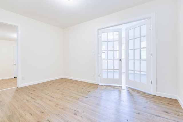 326 River Oaks St, San Angelo, TX 76903 - spare room featuring wood finished floors, baseboards, and french doors
