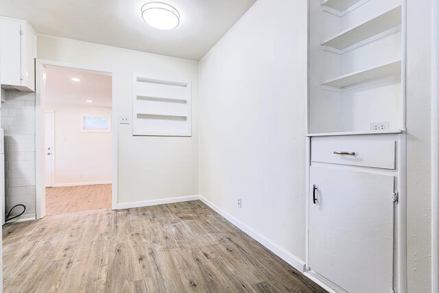 326 River Oaks St, San Angelo, TX 76903 - unfurnished dining area featuring wood finished floors and baseboards