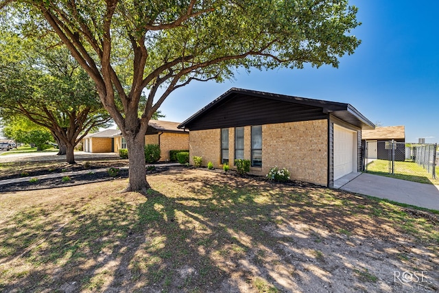 1702 Parkview Dr, San Angelo, TX 76904 - view of front of home with driveway, brick siding, and a garage