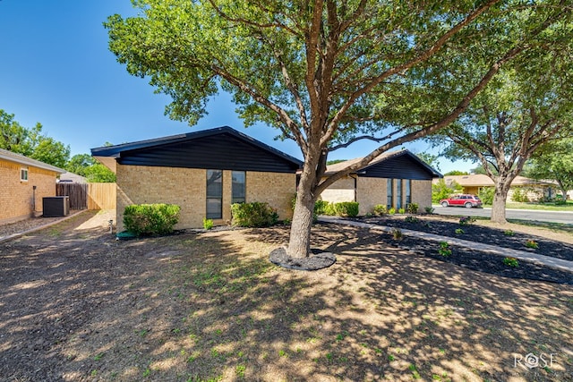 1702 Parkview Dr, San Angelo, TX 76904 - mid-century modern home featuring central AC unit and brick siding